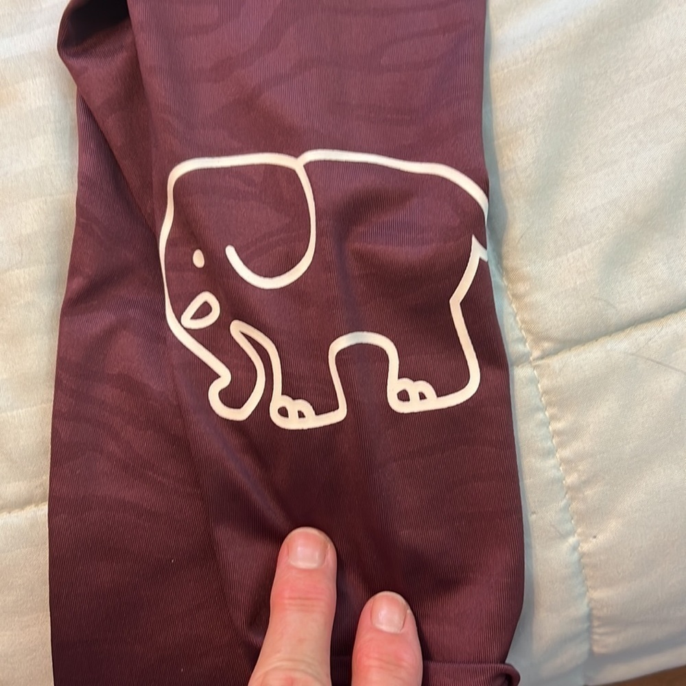 Ivory Ella Maroon colored Leggings, fabric has animal markings throughout